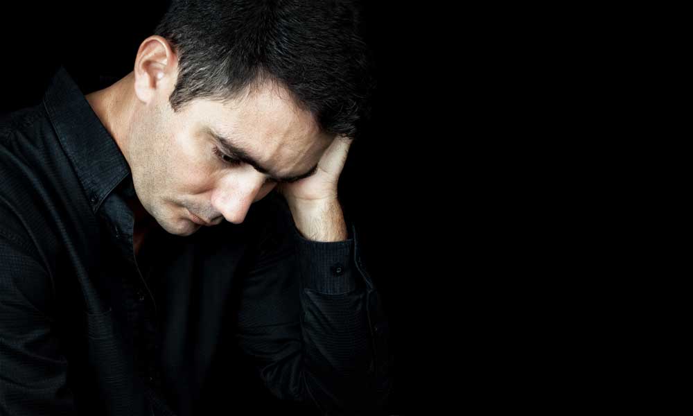 A man suffering from depression before beginning Testosterone Replacement Therapy. TRT can help with symptoms like mild anxiety and depression. Learn more.