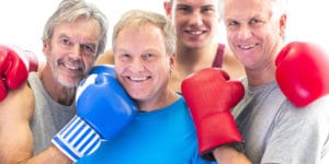 Three senior men in gloves posing with their trainer. Hypothyroidism isn't just a disease that affects women. Men can suffer from underactive thyroid too. Learn more.