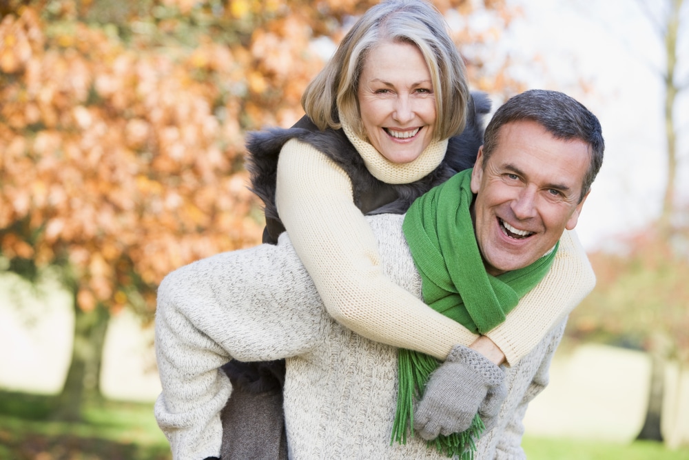 Senior man giving woman piggyback ride through autumn woods. Testosterone therapy may help a woman regain her libido, lose weight. Learn more.