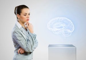 Female professional studies a hologram of the human brain, possibly considering its connection to obesity.